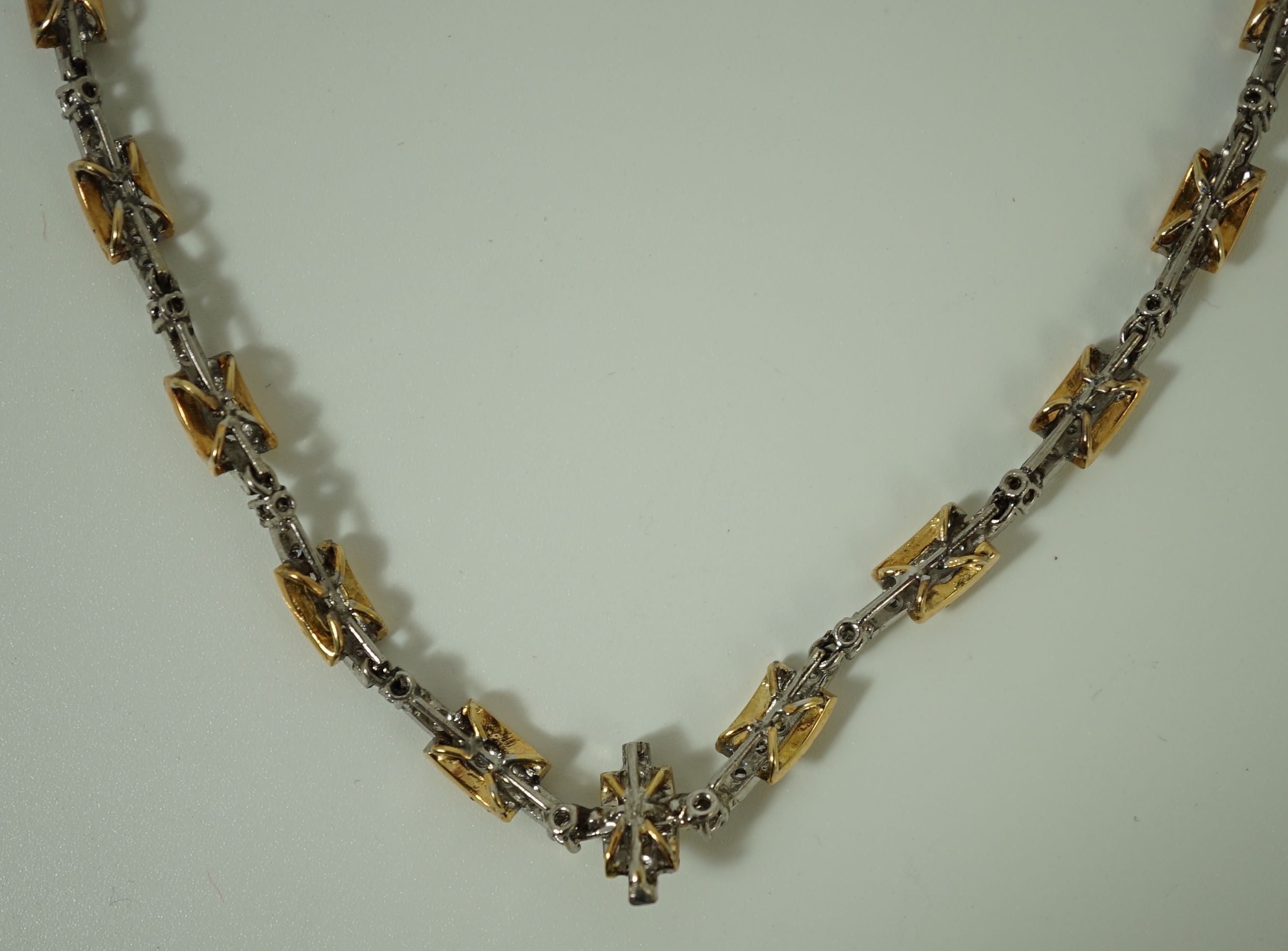 A 20th century two colour gold and diamond set necklace